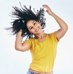 Image showing Hair, dancing and portrait of a woman with afro hairstyle, smile and fashion isolated in a studio white background. Smile, casual and young person with stylish or trendy clothes happy for freedom