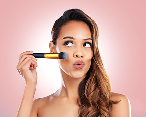 Image showing Beauty, makeup and face of woman with brush on pink background for salon, wellness and luxury. Cosmetology, aesthetic and female person with tools for foundation, cosmetics and glamour in studio