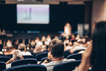 Image showing Speaker giving a talk on scientific conference. Audience at the conference hall. Business and Entrepreneurship concept.