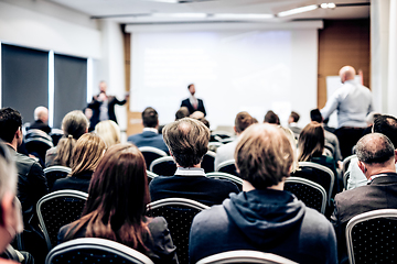 Image showing I have a question. Group of business people sitting in conference hall. Businessman raising his arm. Conference and Presentation. Business and Entrepreneurship