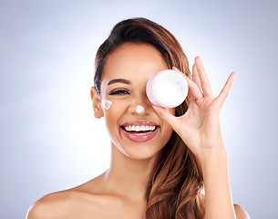 Image showing Portrait, cream jar and beauty of woman in studio with cosmetics product on grey background. Happy female model, face lotion and skincare container for sunscreen, aesthetic dermatology or moisturizer