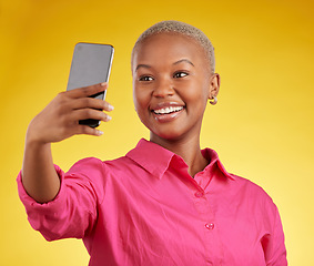 Image showing Smile, selfie and happy black woman in studio isolated on a yellow background. Profile picture, photographer and African person or influencer taking photo for memory, social media or blog on internet