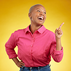 Image showing Happy, black woman and hand pointing in studio for news, deal or coming soon announcement on yellow background. Finger, smile and excited African female show list, promo or sign up contact info