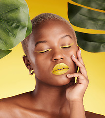 Image showing Calm black woman, makeup and natural beauty in relax for cosmetics with leafs against a yellow studio background. Face of African female person with eyes closed in satisfaction for facial treatment