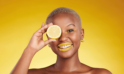 Image showing Happy black woman, portrait and lemon for vitamin C or natural beauty against a yellow studio background. African female person smile with organic citrus fruit for diet or detox with facial makeup