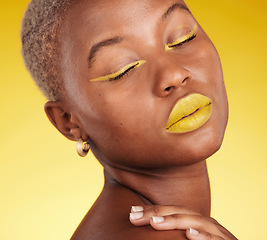 Image showing Cosmetic, art and woman in a studio with makeup eyeliner and lipstick for cosmetology. Beauty, creative and young African female model with a colorful glamour face routine by a yellow background.