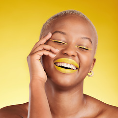 Image showing Happy black woman, makeup and cosmetics for skincare, art or fashion against a yellow background. Face of African female person smile in satisfaction for lipstick, beauty product or facial treatment