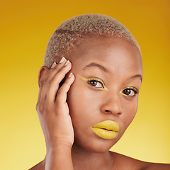 Image showing Portrait, cosmetics and african girl with creative for glow in yellow studio with background in closeup. Woman, serious and skincare with bright makeup with hand on face for dermatology or wellness.