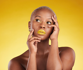 Image showing Thinking, makeup and a black woman on a studio background for art or fashion. Ideas, gold and an African girl or model with yellow lipstick, cosmetics or young beauty on a backdrop for creativity