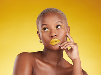 Image showing Thinking, makeup and a black woman on a studio background for creativity or fashion. Ideas, gold art and an African girl or model with yellow lipstick, cosmetics or young beauty on a backdrop