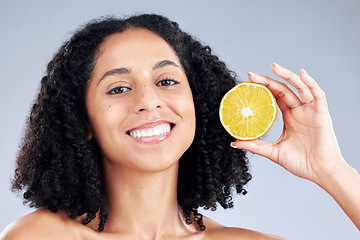 Image showing Woman, lemon and skincare in studio portrait with smile, health and nutrition for wellness by background. Girl, African model and fruit for face, cleaning or cosmetics for beauty, self care or change