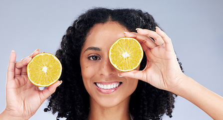 Image showing Portrait, skincare and woman with lemon eye for wellness or nutrition in grey studio background. Happy face, girl and vitamin c for dermatology with smile, fruit, diet or natural facial treatment.