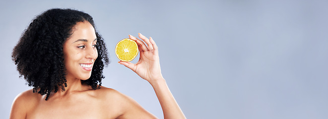 Image showing Smile, beauty and a woman with a lemon on a studio background for vitamin c and natural detox. Happy, nutrition space and a young model with fruit on a mockup banner for wellness, skincare and health