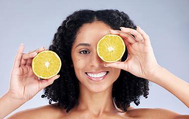 Image showing Girl, skincare and lemon eye for wellness in portrait for natural beauty in grey studio background. Happy face, hand and vitamin c with woman for dermatology or facial treatment for diet or care.