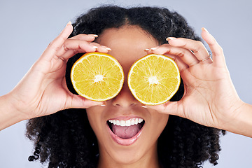 Image showing Woman, lemon eyes and wellness in studio with comic smile, health and skincare with nutrition by background. Girl, model and fruit for diet, cleaning or cosmetics with beauty, self care and emoji