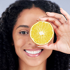 Image showing Portrait, wellness and woman with lemon eye for nutrition in closeup in grey studio background. Skincare, girl and vitamin c for facial treatment with natural organic food for dermatology or fruit.