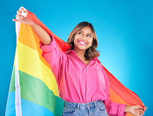 Image showing Lgbtq flag, freedom and woman with support, pride and transgender right on a blue studio background. Female person, lesbian or model with symbol for queer community, equality or celebration with hope