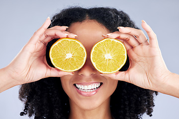 Image showing Woman, lemon eyes and skincare in studio for comic smile, health or nutrition for wellness by background. Girl, African model and fruits for diet, cleaning and cosmetic for beauty, self care or emoji