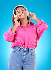 Image showing Young woman, headphones and music, audio streaming service and techno or student podcast in studio. Happy person listening to radio with gen z electronics and wellness on a blue, gradient background