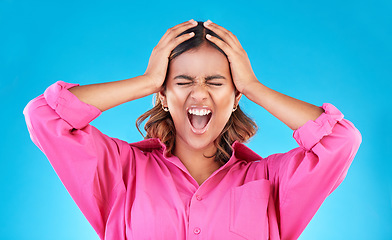 Image showing Angry, frustrated and a shouting woman on a blue background with a anger about mental health. Stress, bipolar and a young screaming Indian girl with a fail or mistake isolated on a studio backdrop