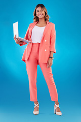 Image showing Computer, fashion and business woman for online marketing, social media planning or copywriting portrait in studio. E commerce, designer suit and full body of person on a laptop and blue background