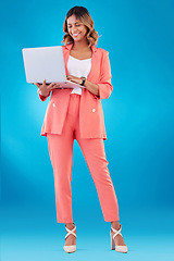 Image showing Laptop, fashion and business woman with online marketing, social media planning or copywriting research in studio. E commerce, creative suit and full body of person on a computer and blue background