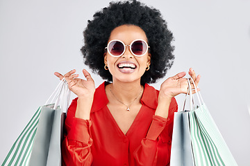 Image showing Happy black woman, face and shopping bags for fashion or style against a white studio background. Portrait of African female person, customer or shopper smile for discount, sale or deal in happiness