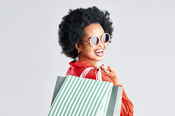 Image showing Happy black woman, afro and shopping bags for discount, sale or fashion deal against a white studio background. Portrait of African female person, customer or shopper smile for purchase in happiness