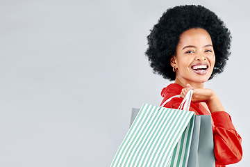 Image showing Shopping bag, portrait and young woman for fashion discount, sale and retail promotion on a white background. Gift, giveaway and happy customer, model or african person with mockup space in studio