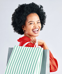 Image showing Shopping bag, portrait and woman excited for fashion discount, cosmetics sale in retail on a white background. Gift, beauty giveaway and young customer, model or african person laughing in studio