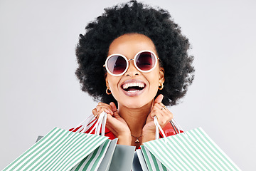 Image showing Happy black woman, face and shopping bags for fashion or style against a white studio background. Portrait of African female person, customer or shopper smile for discount, sale or deal in happiness