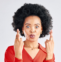 Image showing Woman, fingers crossed or portrait of surprise in studio for good luck on white background. Face of female model hope for bonus, promotion and winning giveaway with hand emoji, sign and lottery prize