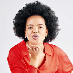 Image showing Portrait, happy and black woman blowing a kiss, flirty and seductive against a white studio background. Face, female person or model being alluring, kissing or love with romantic gesture or happiness