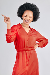 Image showing Pointing, portrait and black woman with a smile, promotion and presentation against a white studio background. Happy, female person or model with hand gesture, happiness or discount deal with a sale