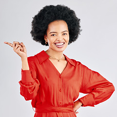 Image showing Portrait, pointing and black woman opportunity, smile and happiness against a white studio background. Face, female person and model with hand gesture, showing and choice with discount deal and sales