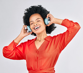 Image showing Black woman, headphones and happy music in studio for podcast subscription on white background. Face, freedom and female model smile while listening to audio, streaming sound or hearing song on radio