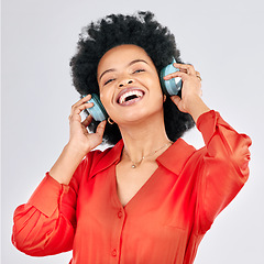 Image showing Music, headphones or happy black woman listening to radio playlist to relax on white background in studio. Hearing, freedom or African person dancing, smiling or streaming a song audio or sound track