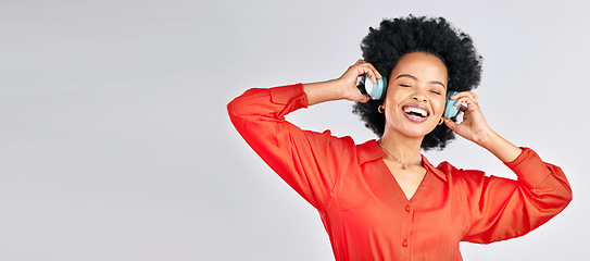 Image showing Black woman, music and headphones in mockup studio for podcast, subscription and banner space on white background. Face, freedom and happy model streaming radio, listening to sound and hearing audio