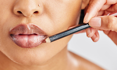 Image showing Closeup, woman and lip pencil for makeup, facial skincare and hands with beauty cosmetics in studio. Mouth, female model and lipstick product for outline of lips, aesthetic makeover and application