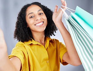 Image showing Shopping bag, selfie and woman in portrait for discount, sale and happy on white background. Retail, face and fashion influencer, african person or customer with profile picture photography in studio