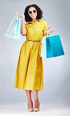 Image showing Happy woman, portrait and shopping bags for fashion or style against a white studio background. Excited female person, customer or shopper smile for discount, sale or purchase in promotion with gifts