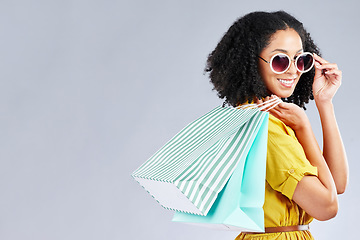 Image showing Shopping, bag and woman happy for retail sale, promotion or excited for discount on studio, mockup or grey background. Customer, portrait or girl to shop for fashion or sales on luxury clothing