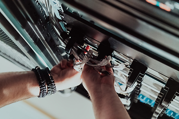 Image showing Close up of technician setting up network in server room