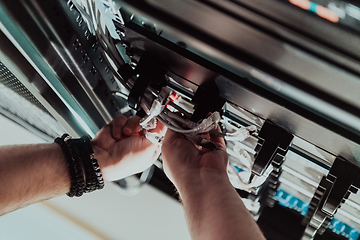 Image showing Close up of technician setting up network in server room