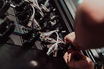 Image showing Close up of technician setting up network in server room