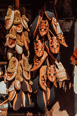 Image showing Macedonian folklore, brown sandals. Old shoes. Part of the tradition. Black pants, close up