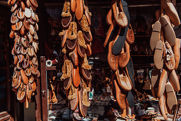 Image showing Macedonian folklore, brown sandals. Old shoes. Part of the tradition. Black pants, close up