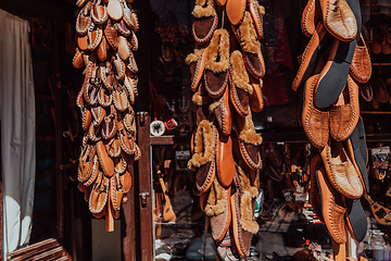 Image showing Macedonian folklore, brown sandals. Old shoes. Part of the tradition. Black pants, close up