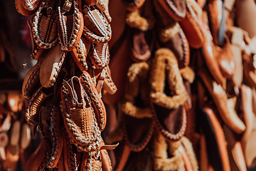 Image showing Macedonian folklore, brown sandals. Old shoes. Part of the tradition. Black pants, close up