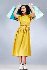 Image showing Excited, celebration and woman with shopping bag for fashion in studio isolated on a white background. Smile, sales and African customer with gift, discount deal or clothes from store, retail or mall